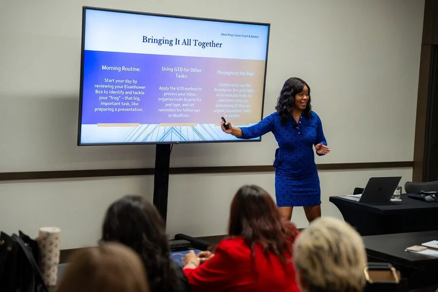 Alexis King speaking to an audience, mid gesture