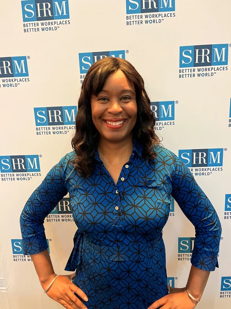 Alexis King standing confidently at a professional conference